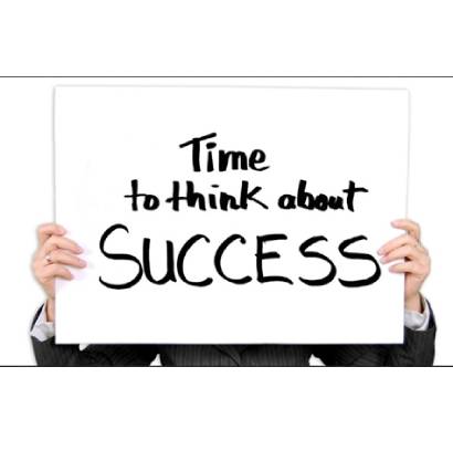 A person holding up a sign that says " time to think about success ".