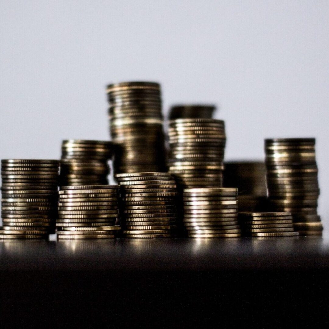 A pile of coins sitting on top of a table.